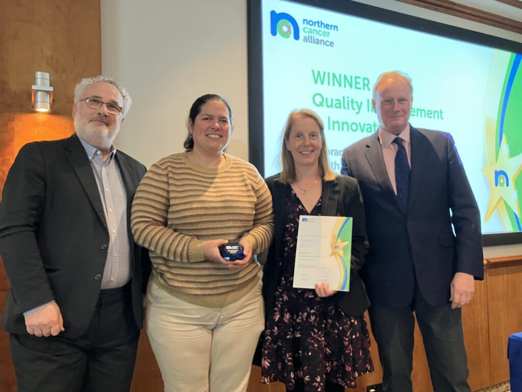 Stacey Stockdale and Rosibel Quintana receiving their award at the Northern Cancer Alliance conference
