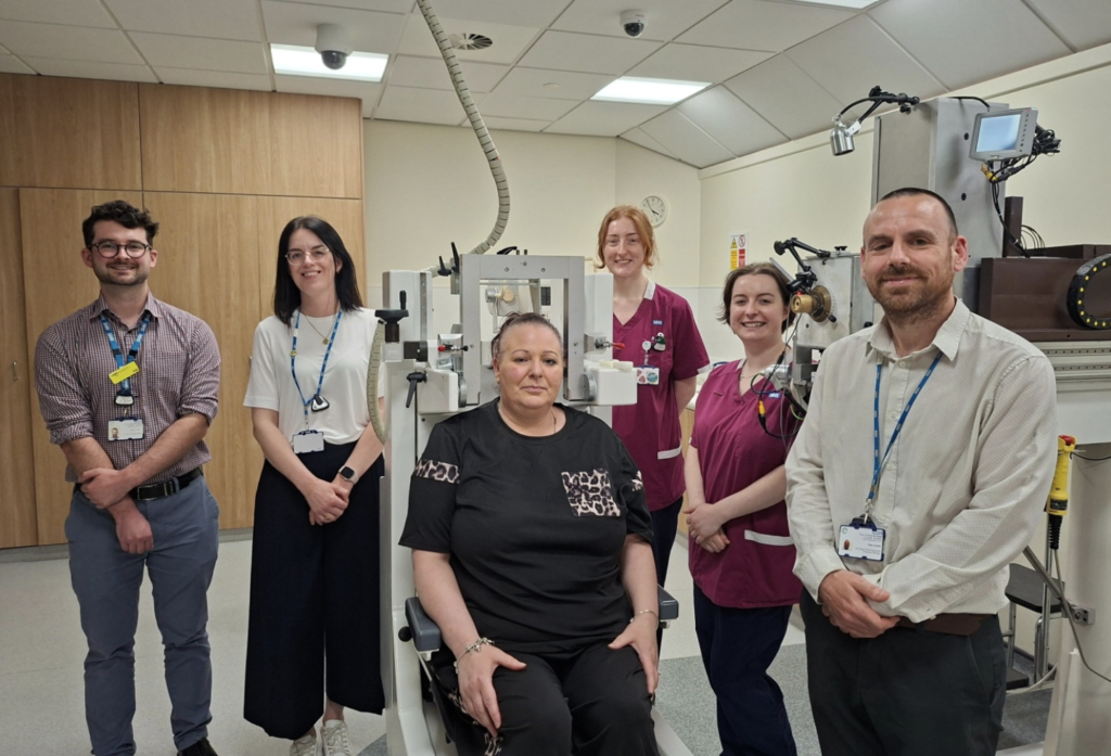 Patient Lydia Harrison (seated) with members of the team including Peter Corlett (right) and Laura Howard (second from left)