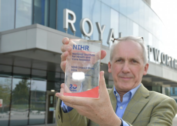 Professor Rintoul holding an NIHR Impact Prize 2026 'commended' trophy