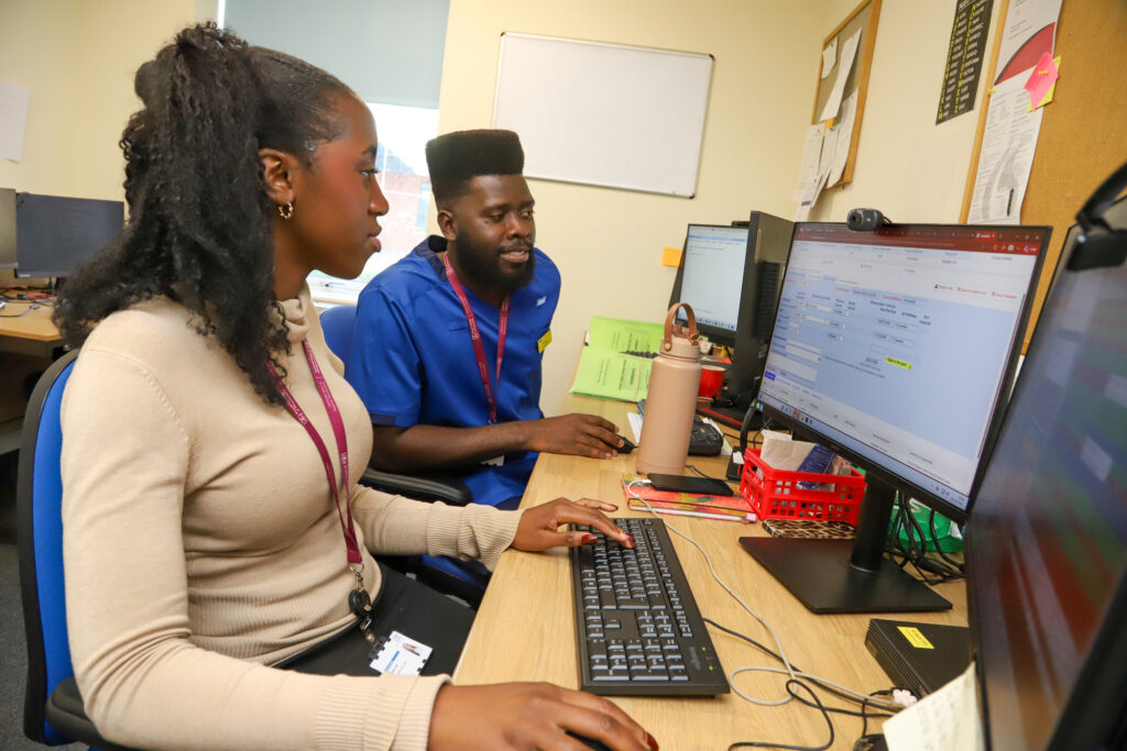 From left - Michelle Talabi, Liver Surveillance Navigator, and Selwyn Semple, Hepatology Clinical Nurse Specialist for liver surveillance, using the new patient digital tracking system that has been introduced at Medway Maritime Hospital.