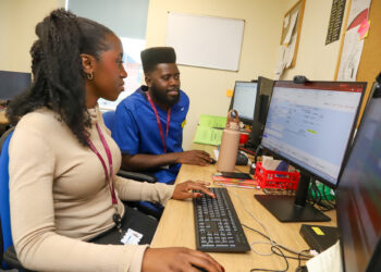From left - Michelle Talabi, Liver Surveillance Navigator, and Selwyn Semple, Hepatology Clinical Nurse Specialist for liver surveillance, using the new patient digital tracking system that has been introduced at Medway Maritime Hospital.